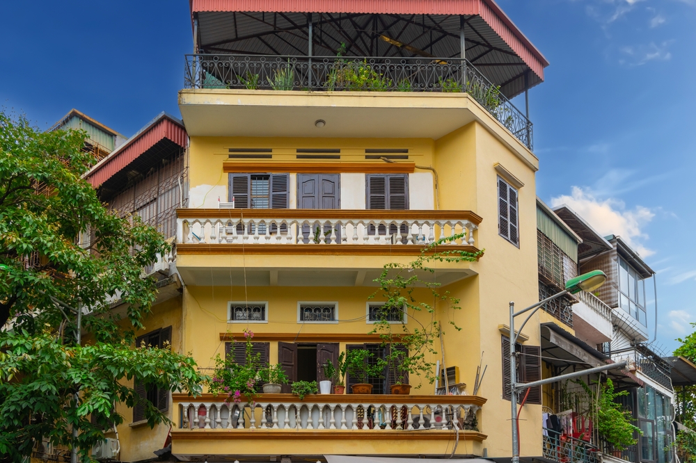Casas altas e estreitas com plantas na fachada no Old Quarter, em Hanói