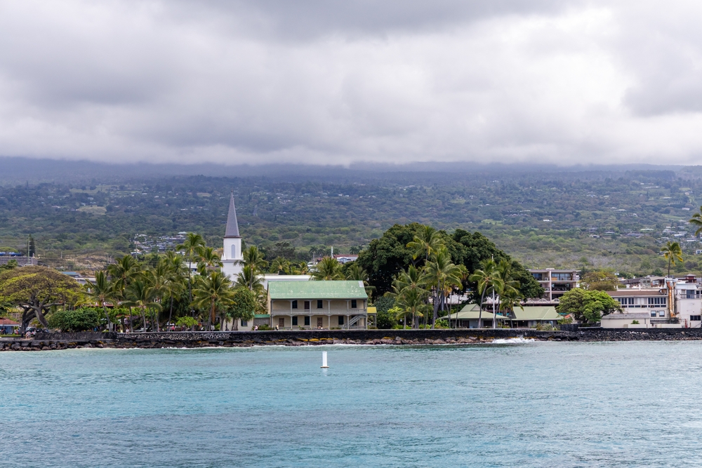 A orla de Kailua-Kona com palmeiras e uma igreja