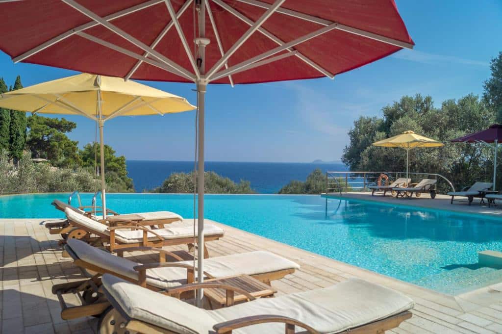 Piscina, guarda-sóis e vista para o mar no Armonia Bay Hotel